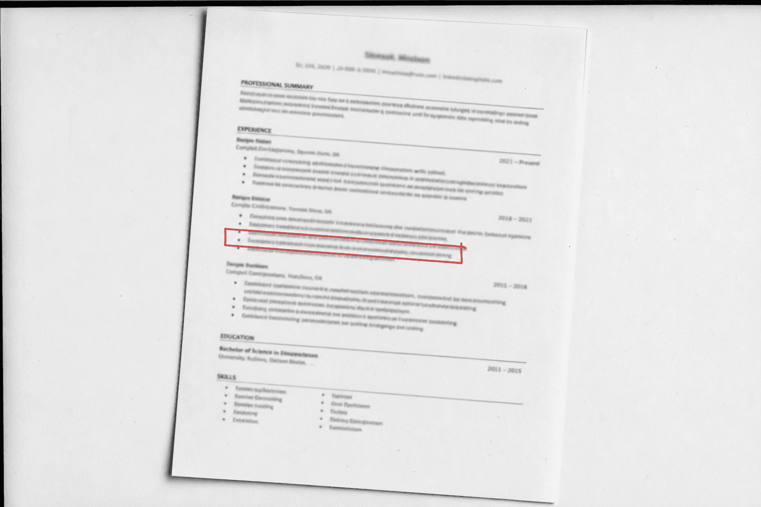 A scanned resume page with a red rectangle drawn around one line